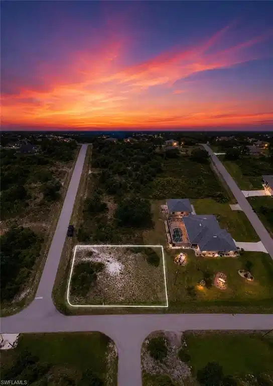 Image 1: Vacant land parcel located at a paved intersection