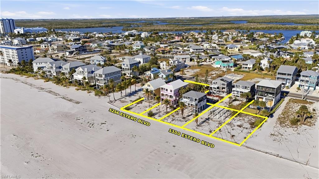 Image 4: Aerial overview of property's location featuring property parcel outlined and a nearby body of water