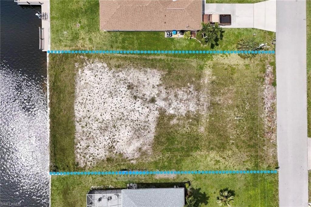 Image 4: Aerial view of property's location featuring property boundaries highlighted and a large body of water