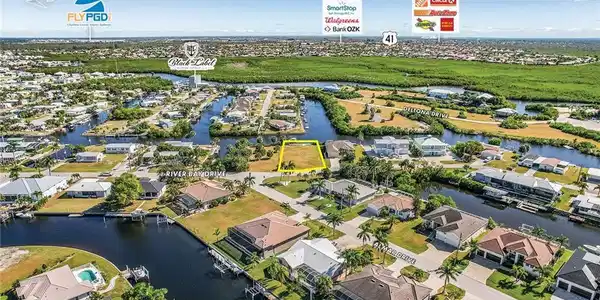 Image 4: Aerial view of residential area featuring a large body of water