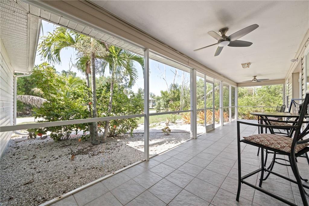 Image 2: Front lanai with wooded view.