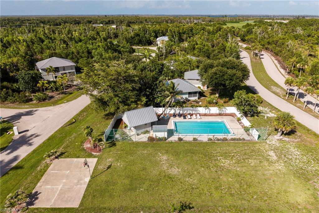 Image 4: Community pool area featuring a private serene setting, and a basketball half-court.
