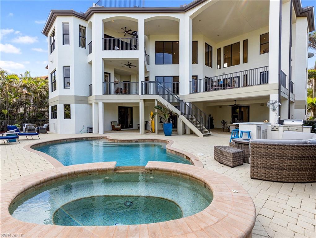 Image 3: View of swimming pool featuring an outdoor living space, an outdoor bar, ceiling fan, an in ground hot tub, and a patio area