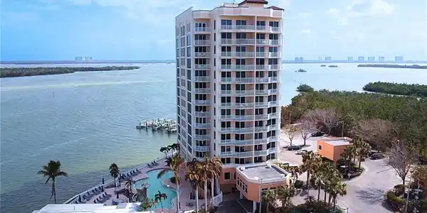 Image 2: View of property with a water view and a community pool Virtually edited image