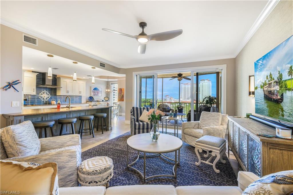 Image 4: Living room with a ceiling fan, crown molding, and light tile patterned floors