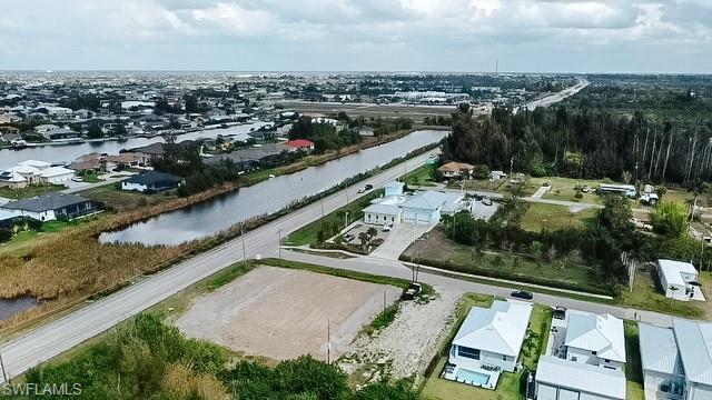 Image 4: Aerial perspective of suburban area with a large body of water