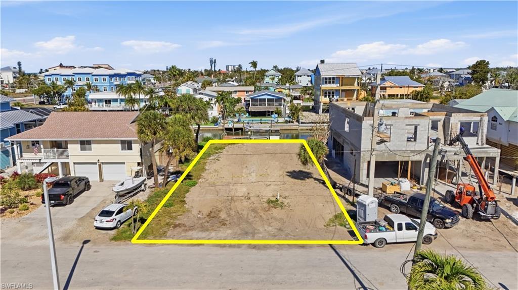 Image 1: Aerial perspective of canal lot with property boundaries highlighted - Virtually Edited Image