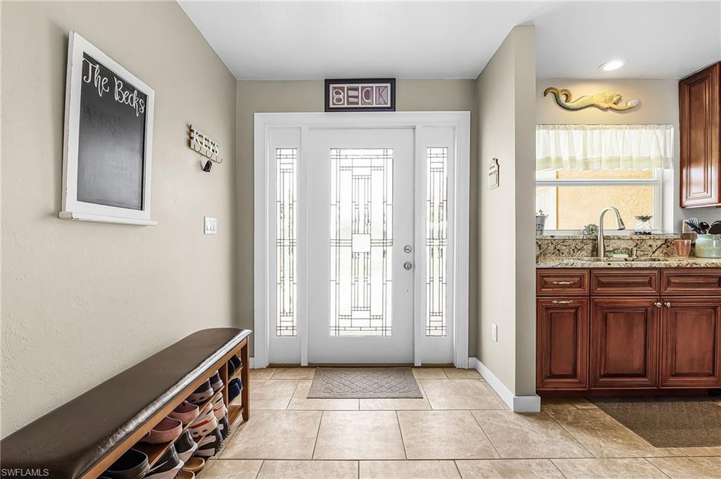 Image 3: Foyer with light tile patterned flooring