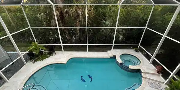 Image 2: Large 2 story screen enclosure with a heated pool and spa.