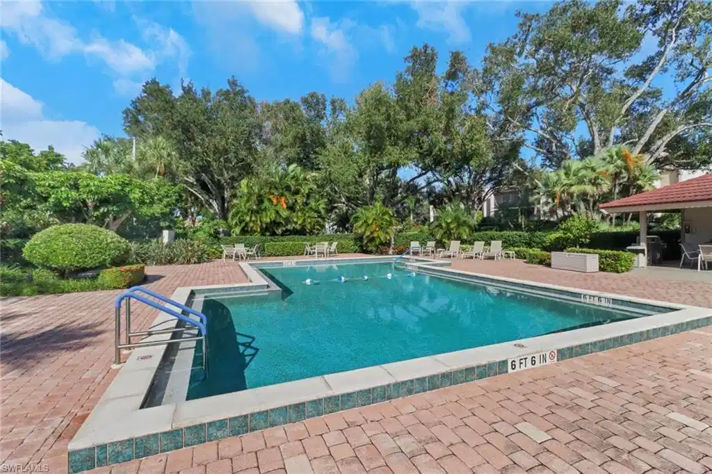 Image 1: View of pool with a patio area