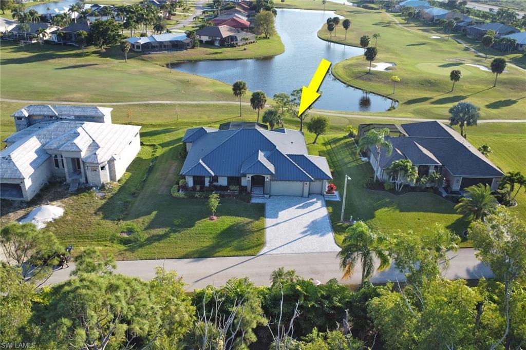Image 1: Aerial view of residential area with a local golf course and a large body of water