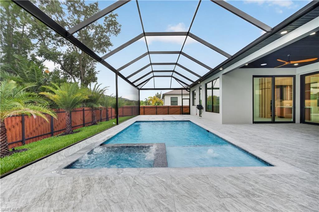 Image 4: Modern architectural design with a dark metal roof and light gray stucco exterior