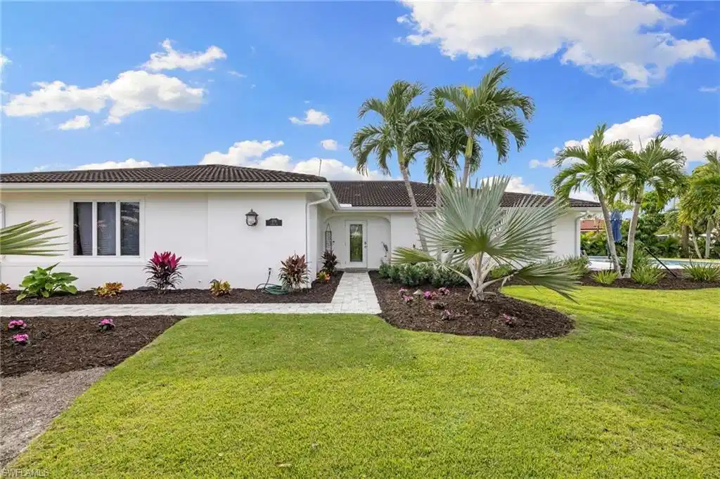 Image 1: View of front of house with a front lawn, stucco siding, and a tiled roof
