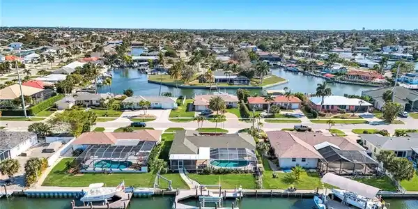 Image 2: Aerial perspective of suburban area with a large body of water