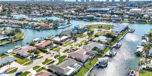 Image 3: Aerial overview of property's location featuring a large body of water and nearby suburban area