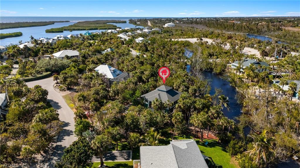 Image 2: Aerial view of residential area with a large body of water