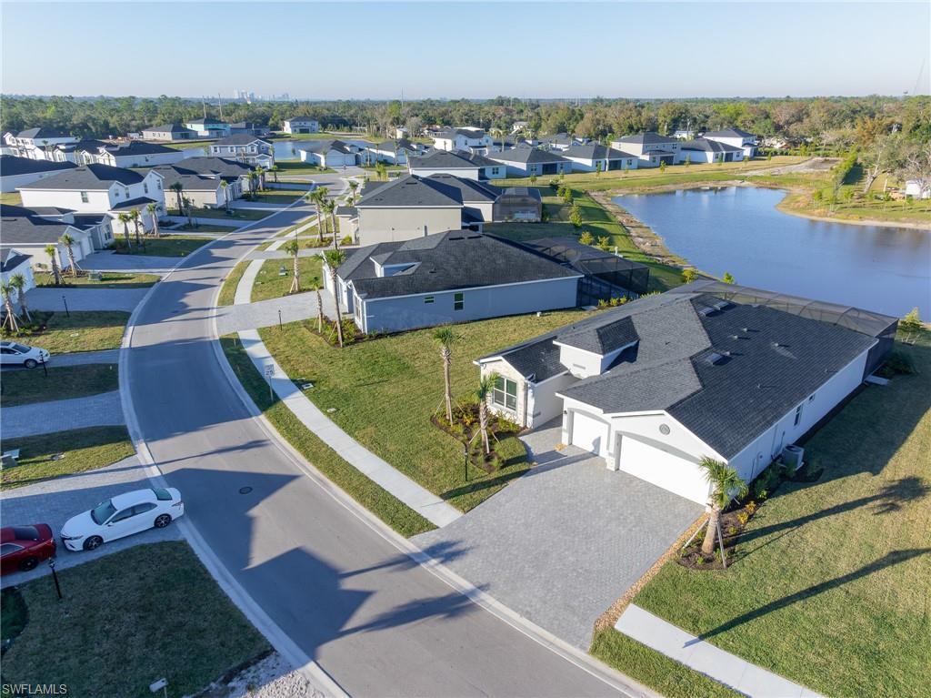 Image 1: Aerial view of residential area featuring a large body of water