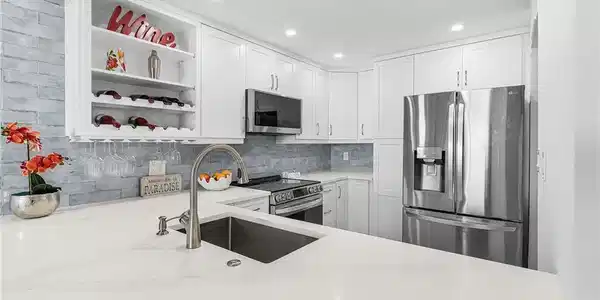 Image 4: Stainless LG ThinQ Smart Appliances. Gorgeous backsplash and lots of storage in this kitchen.