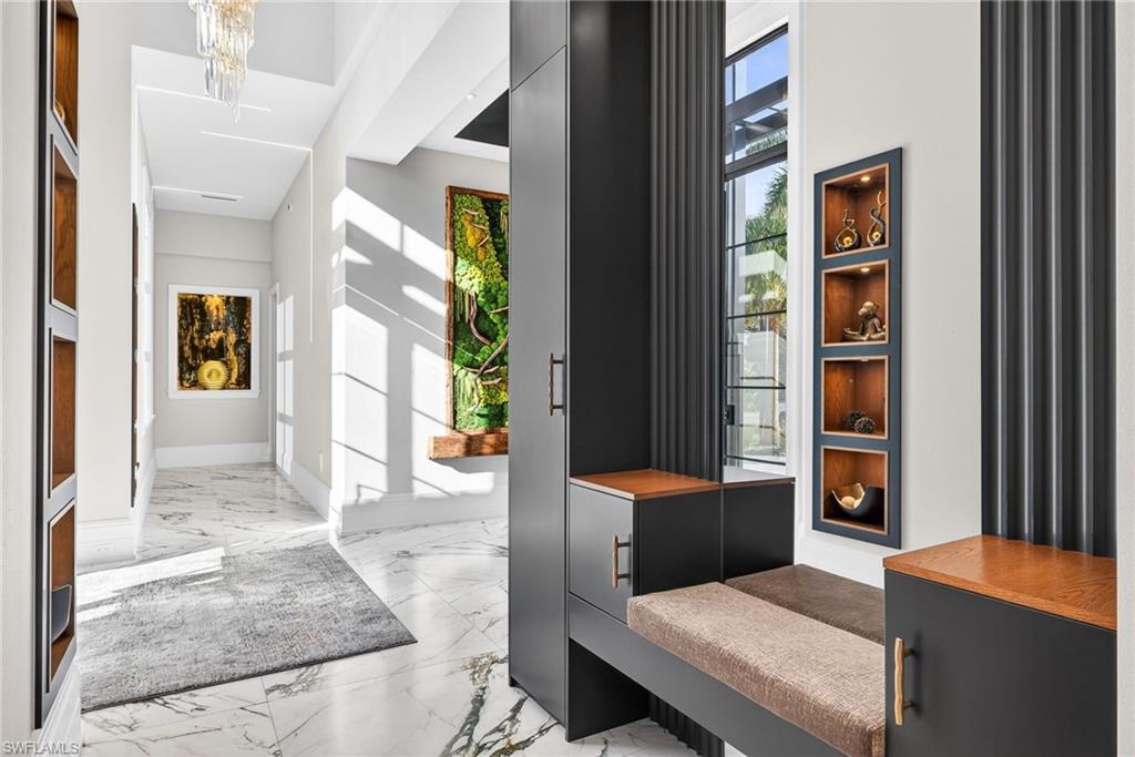 Image 4: Foyer entrance with light marble finish floors and suspended lighting