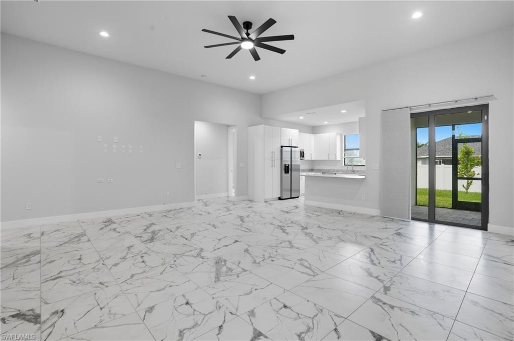 Image 4: Unfurnished living room with recessed lighting, light marble finish flooring, and a ceiling fan