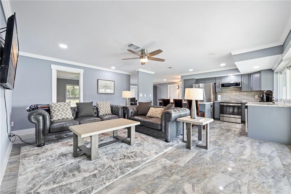 Image 1: Living room featuring a ceiling fan, crown molding, and recessed lighting