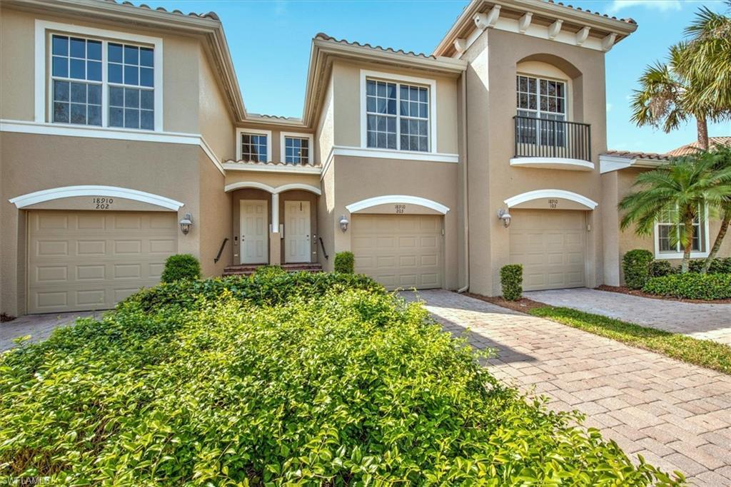Image 1: Mediterranean-style townhouse with stucco exterior and barrel tile roofing
