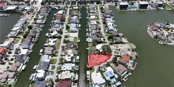 Image 2: View of property location featuring a large body of water and nearby suburban area