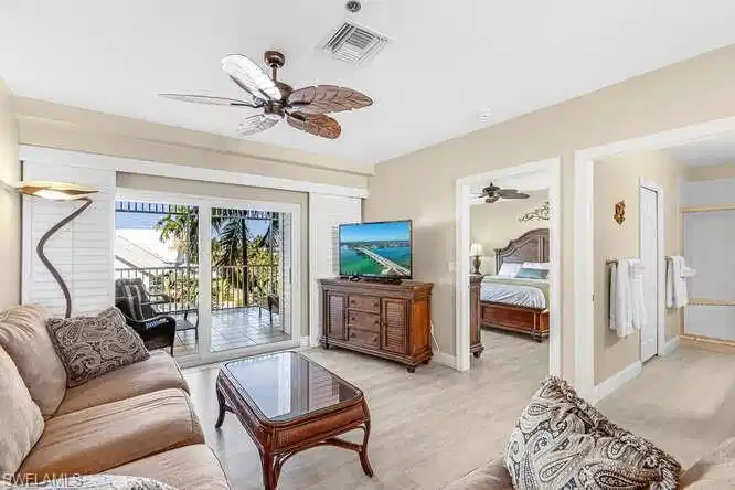 Image 1: Living room with a ceiling fan and light wood finished floors