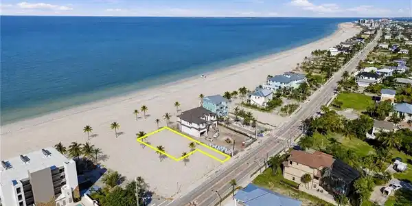Image 4: Beachfront lot with direct access to the sand, situated along a paved road - Virtually Edited Image