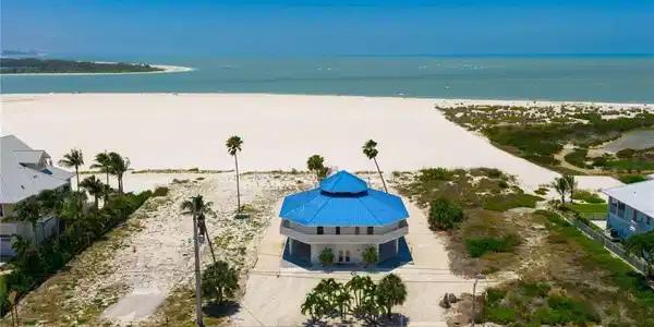 Image 2: Octagonal coastal residence with a vibrant blue multi-tiered roof - Virtually Edited Image