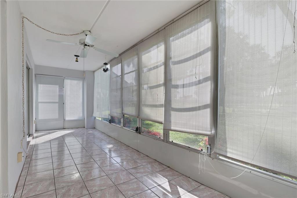 Image 4: Enclosed patio featuring light-toned tile flooring, white walls, and a ceiling fan