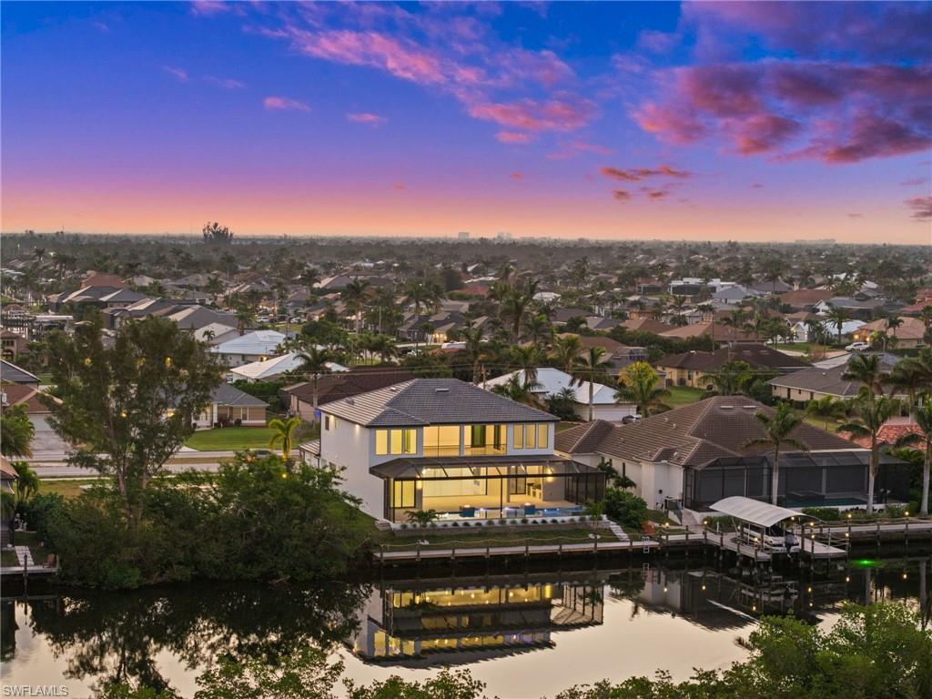 Image 2: Aerial perspective of suburban area featuring a large body of water