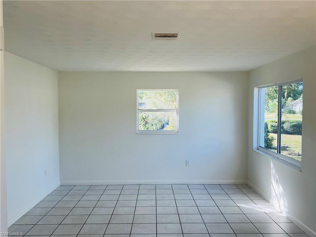 Image 3: Spare room with light tile patterned flooring