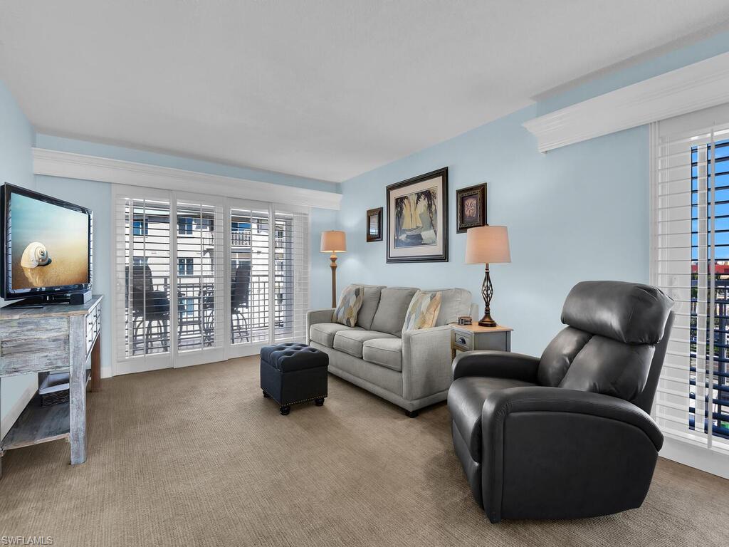 Image 4: Living area with carpet flooring