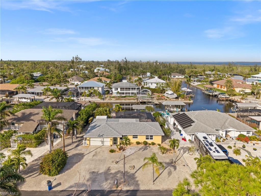 Image 1: Aerial view of residential area with a large body of water