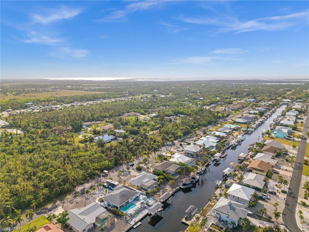 Image 2: Aerial view of property and surrounding area featuring nearby suburban area and a nearby body of water