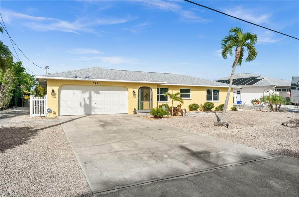 Image 4: Single story home featuring stucco siding, driveway, an attached garage, and a shingled roof