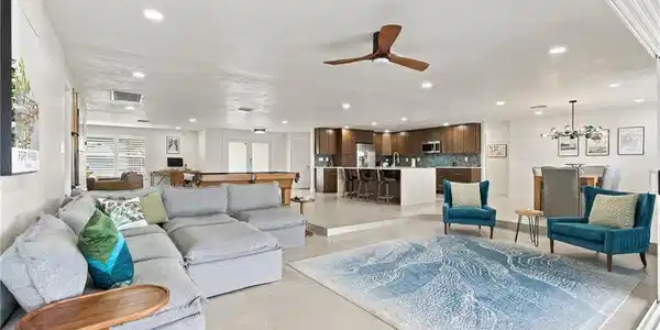 Image 4: Recessed lighting, a modern ceiling fan, and tile flooring complement the open-concept design