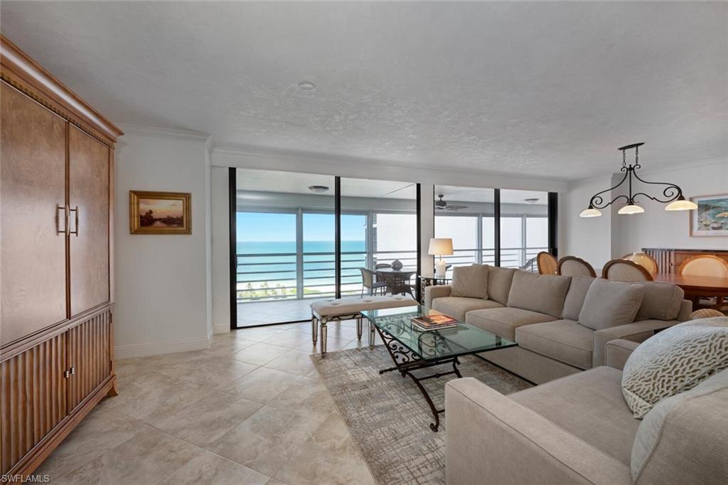 Image 4: Living area with a water view and floor to ceiling windows