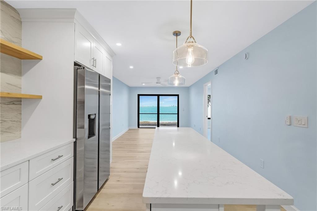 Image 2: Welcome to easy island living from this beautifully remodeled first-floor bayfront condo.
