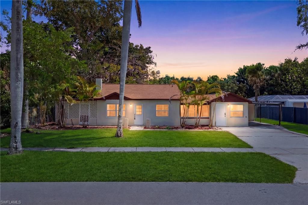 Image 4: Beautifully captured front exterior featuring glowing sunset skies behind the home, creating a dramatic and inviting scene.