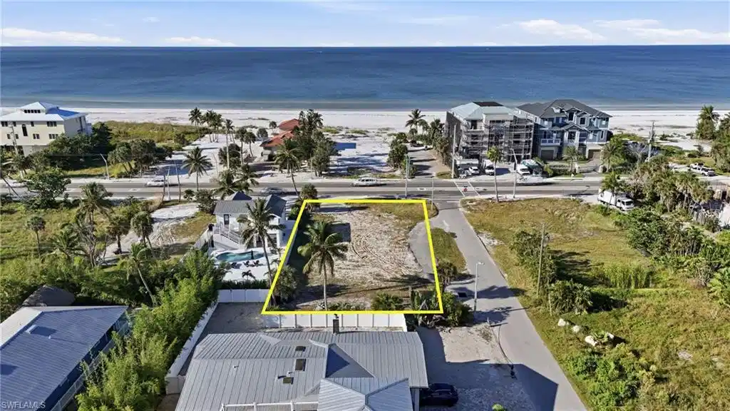 Image 1: Aerial view of property and surrounding area featuring property boundaries highlighted - Virtually Edited Image