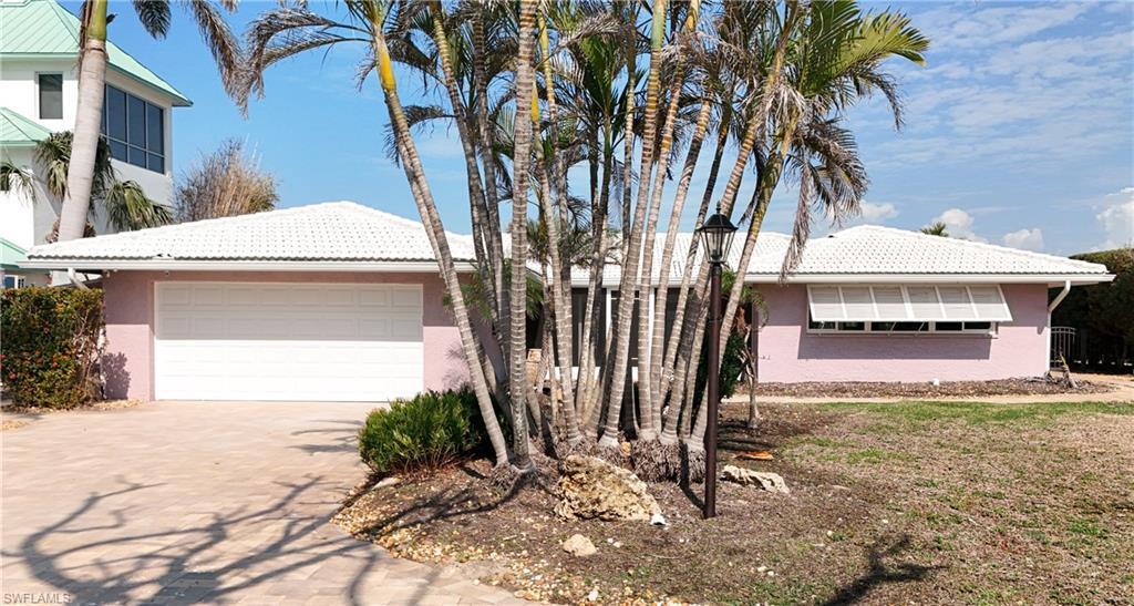 Image 3: Ranch-style home featuring stucco siding, decorative driveway, and 2 car garage