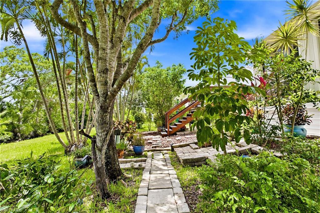 Image 4: A true backyard haven with room to relax, entertain, garden, and enjoy year-round Southwest Florida living.