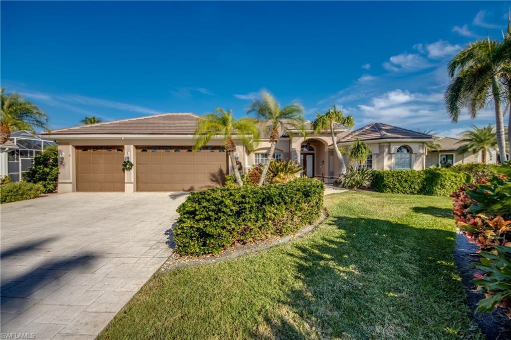 Image 2: Mediterranean / spanish house featuring stucco siding, a front lawn, concrete driveway, and a tiled roof