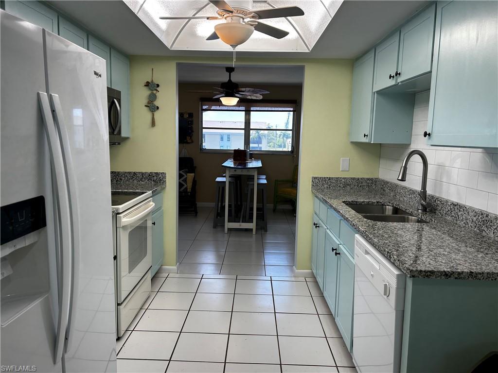 Image 3: New Granite tops in kitchen, new faucet, new sink, new microwave, new tiled backsplash and new cabinet doors