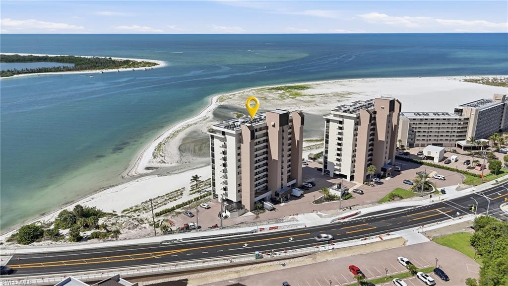 Image 2: Aerial perspective showcasing multi-story residential buildings situated along a coastline - Virtually Edited Image
