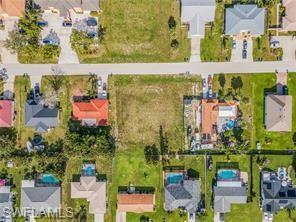 Image 3: Aerial view of property and surrounding area featuring nearby suburban area