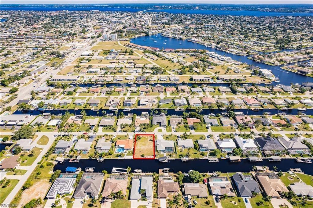 Image 2: Aerial view of residential area with a large body of water