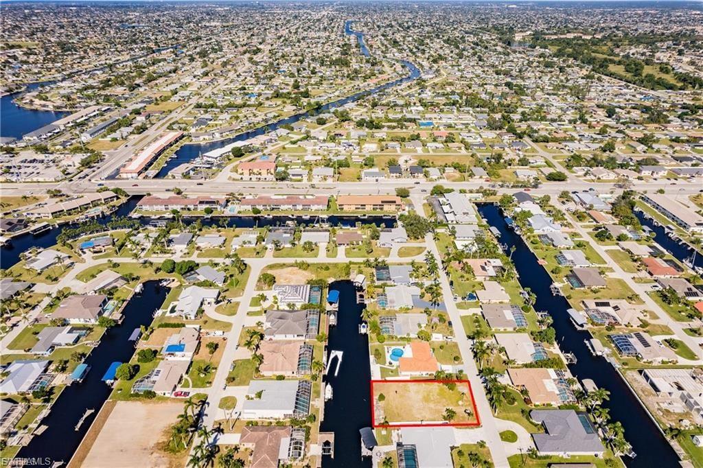 Image 4: Aerial view of residential area featuring a large body of water
